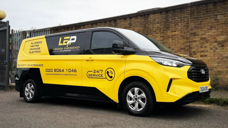 Custom van wrap on a Ford Transit featuring yellow and black design for London Emergency Plumbing, highlighting vehicle branding and 24/7 service.