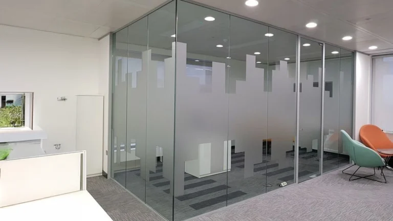 Frosted glass window film with a modern cityscape pattern applied to office glass partitions for privacy and aesthetics.