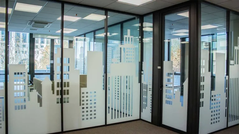 Frosted window graphics featuring a modern cityscape design on office glass partitions.