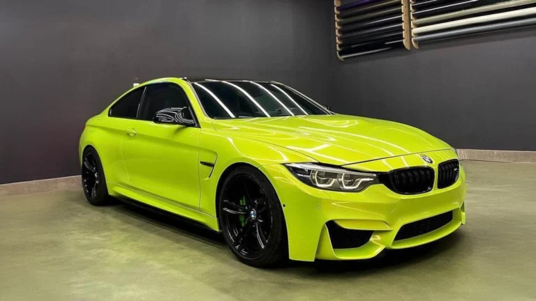 BMW M4 wrapped in a vibrant gloss lime green finish. Expert colour change car wrapping with custom detailing, PPF protection, and window tinting services.