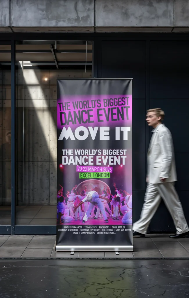 A tall vertical black and pink roller banner for the "MOVE IT" dance event at ExCeL London, featuring photos of dancers and event dates, displayed at a building entrance