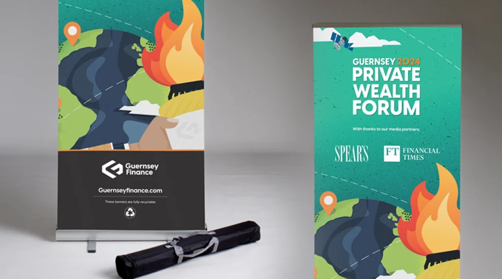 Two vertical roller banners for the Guernsey 2024 Private Wealth Forum featuring illustrative graphics of a globe and torch, with a black carry case on the floor