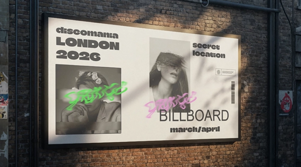 arge horizontal outdoor billboard mounted on a brick wall, featuring "Discomania London 2026" event branding with graffiti-style overlays.