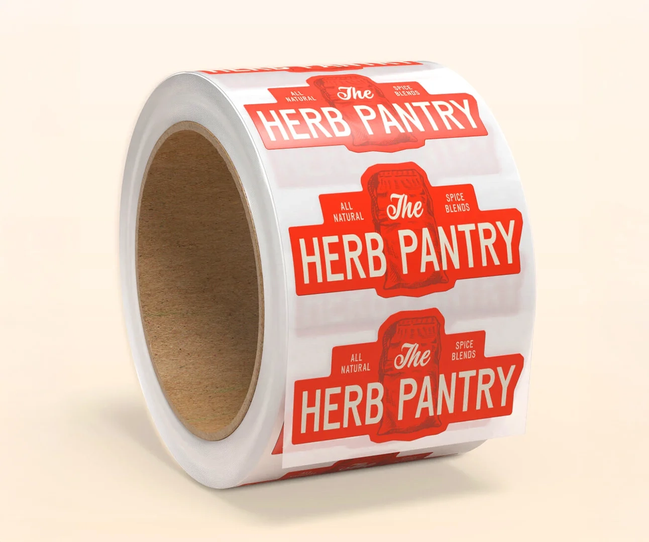 A roll of custom-printed adhesive labels for "The Herb Pantry" featuring a red and white design with vintage-style typography and an illustration of a spice sack.