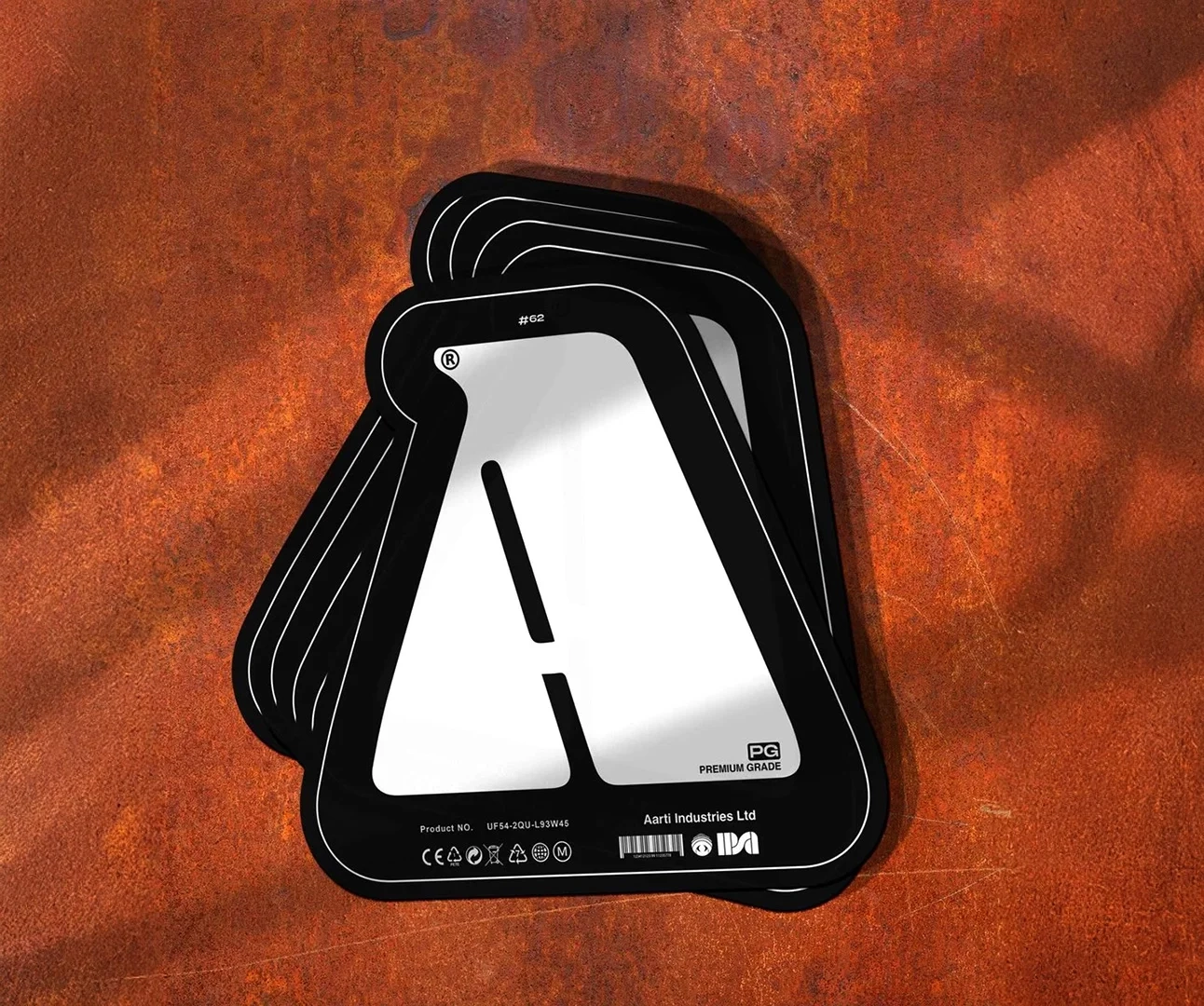 A stack of thick, die-cut black and silver industrial labels for Aarti Industries Ltd, featuring a large white letter 'A', product numbers, and safety compliance icons.